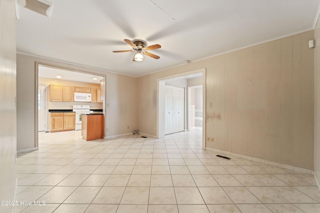 tiled spare room featuring crown molding and ceiling fan