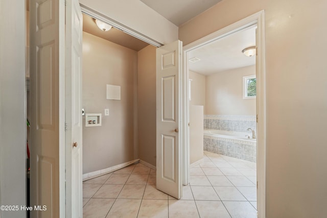 interior space featuring tile patterned floors and tiled bath