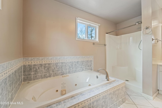 bathroom with tile patterned floors and tiled bath