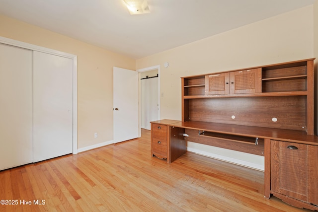 unfurnished office featuring light wood-type flooring