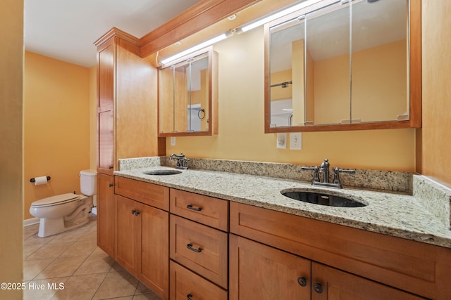 bathroom featuring vanity, tile patterned floors, and toilet