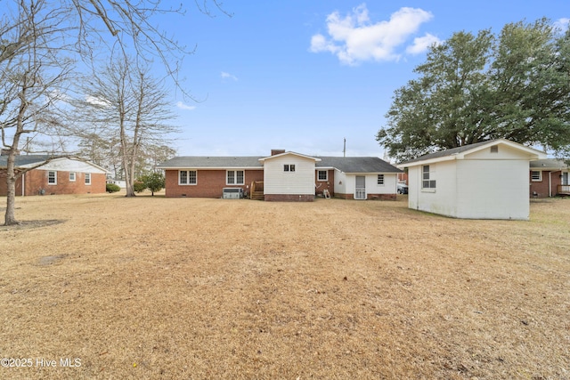 rear view of house with a lawn