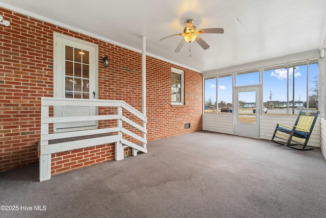 unfurnished sunroom with ceiling fan