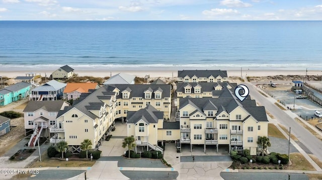 bird's eye view featuring a water view and a view of the beach