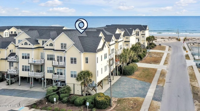 birds eye view of property with a view of the beach and a water view