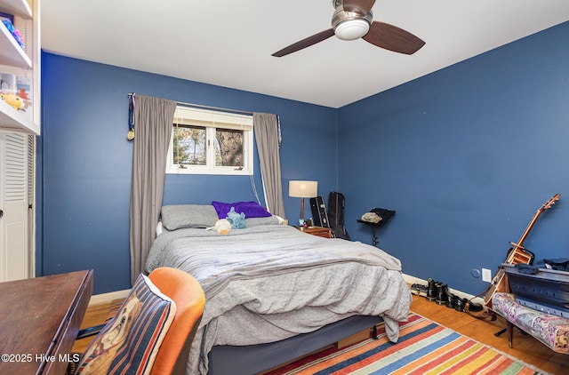 bedroom with wood-type flooring and ceiling fan