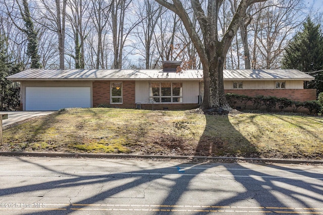 ranch-style house with a garage and a front yard