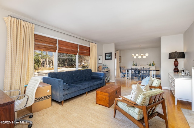 living room with a notable chandelier and light wood-type flooring