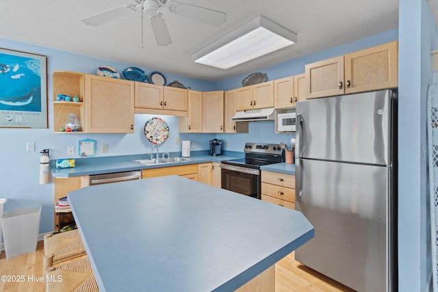 kitchen with appliances with stainless steel finishes, sink, and light brown cabinets