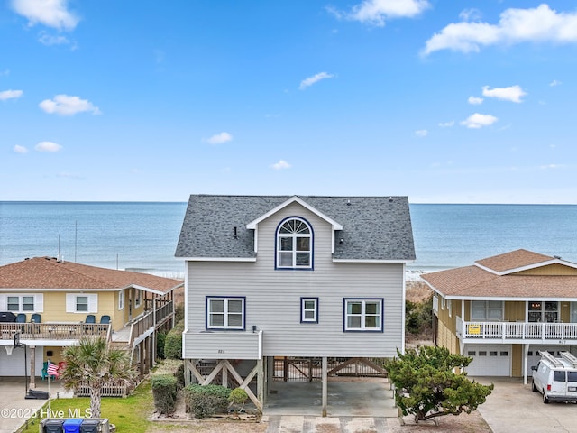 view of front of home featuring a carport and a water view