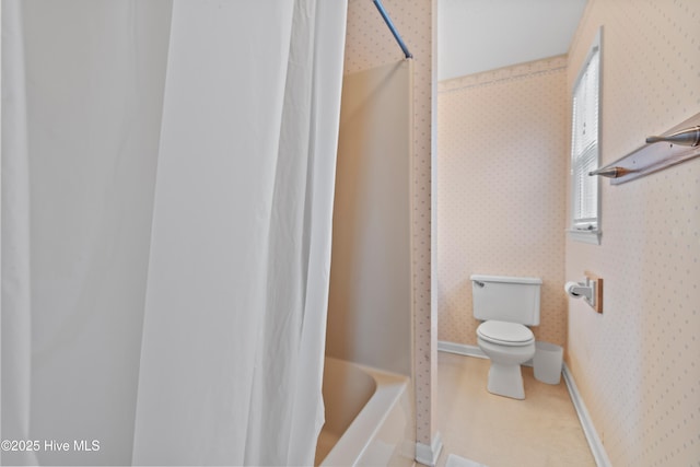 bathroom with shower / bath combination with curtain and toilet