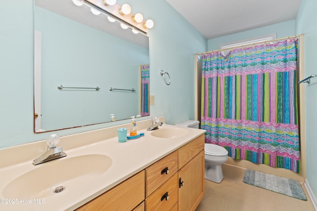 bathroom featuring vanity, toilet, and curtained shower