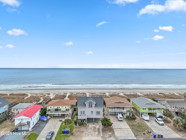 aerial view with a water view and a beach view