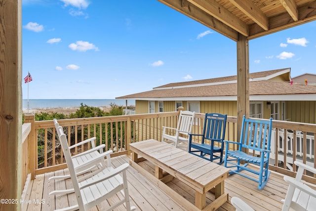 wooden terrace with a water view and a beach view