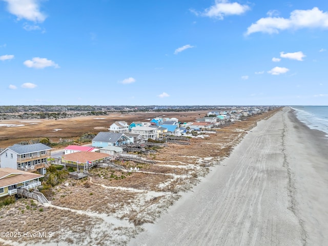 drone / aerial view featuring a beach view and a water view