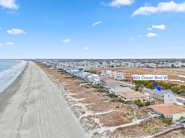 drone / aerial view with a water view and a view of the beach