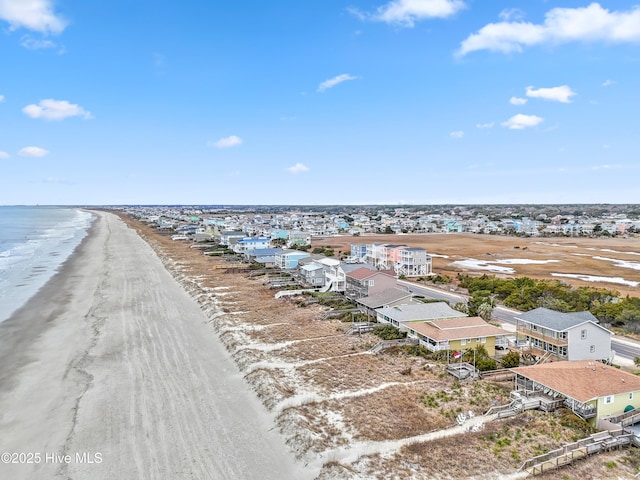 birds eye view of property featuring a view of the beach and a water view