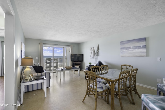 dining space featuring a textured ceiling