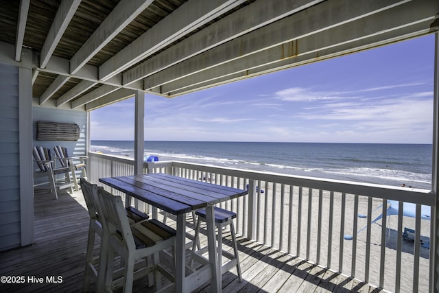 deck featuring a water view and a beach view