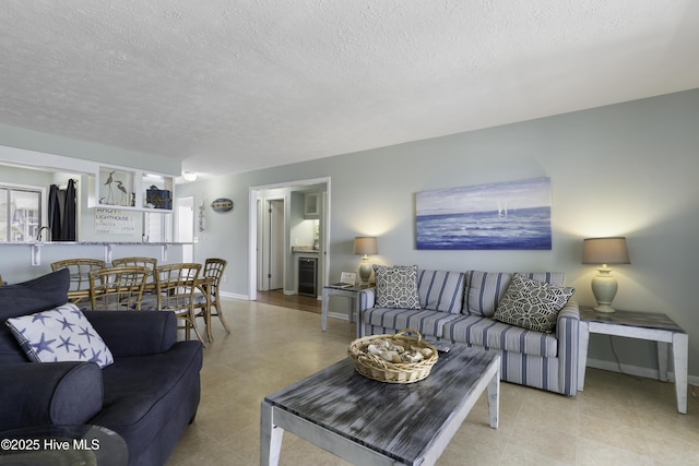 living room with beverage cooler and a textured ceiling