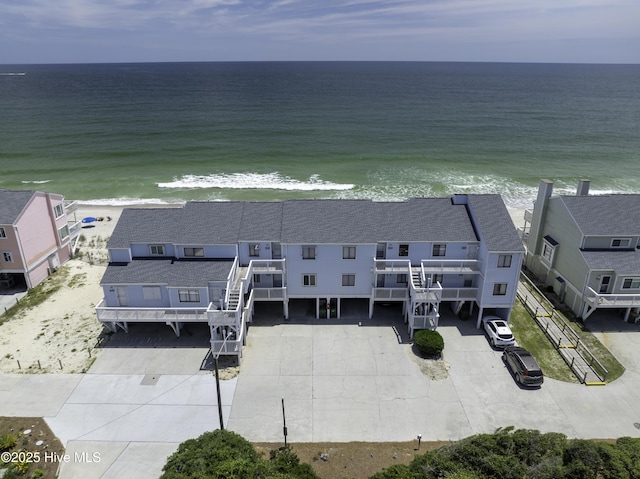 bird's eye view featuring a water view and a view of the beach