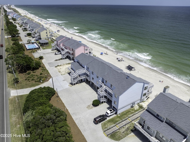 drone / aerial view featuring a water view and a beach view