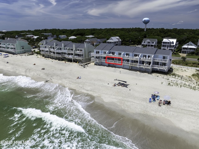 bird's eye view with a water view and a beach view