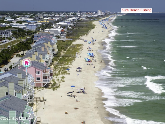 bird's eye view featuring a water view and a beach view