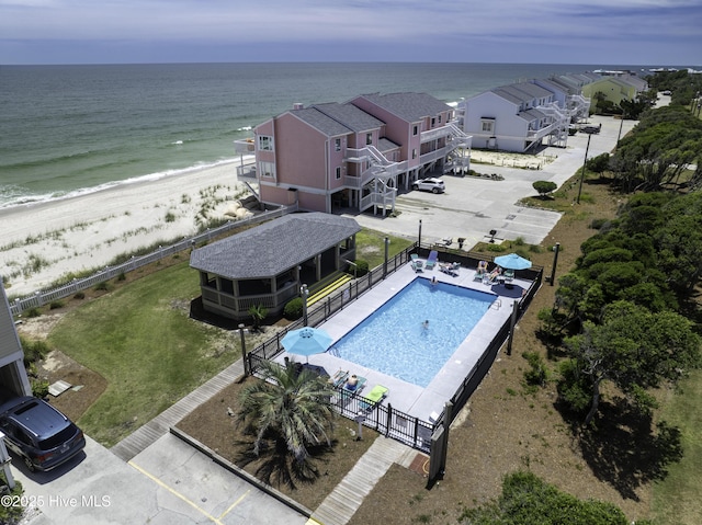 drone / aerial view with a beach view and a water view