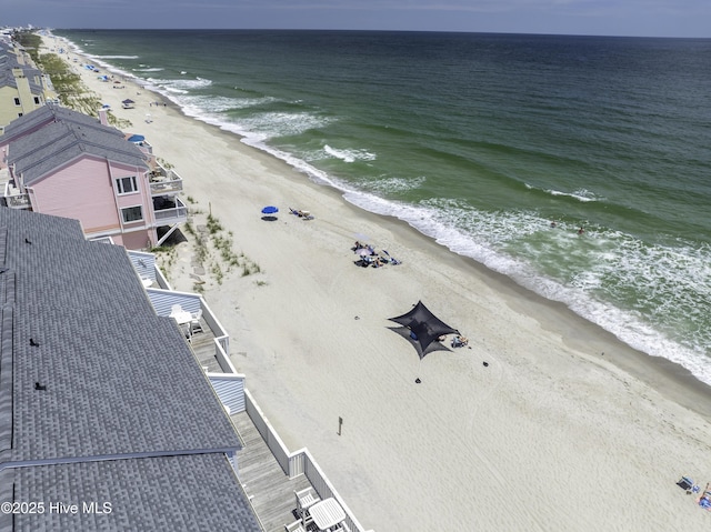 bird's eye view with a water view and a beach view