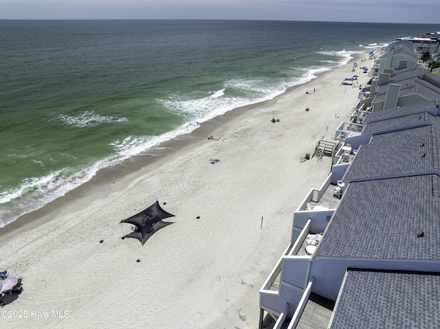 bird's eye view with a water view and a beach view