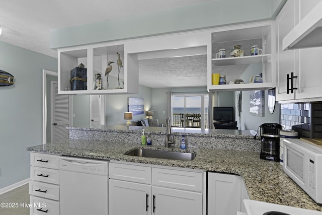 kitchen featuring sink, white appliances, white cabinetry, extractor fan, and light stone countertops