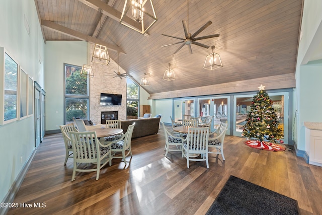 dining room featuring dark hardwood / wood-style floors, high vaulted ceiling, a fireplace, beamed ceiling, and wooden ceiling