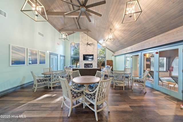 dining space with plenty of natural light, a fireplace, and french doors