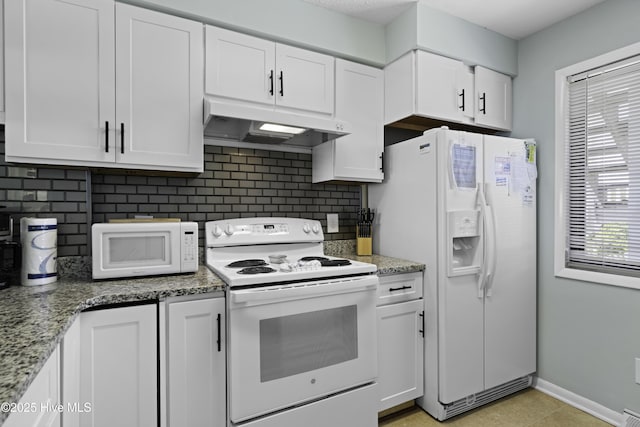 kitchen featuring light stone countertops, backsplash, white cabinets, and white appliances