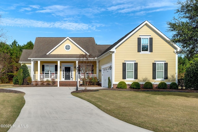 view of front of property with a front yard, covered porch, an attached garage, and concrete driveway