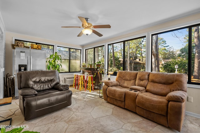 sunroom with ceiling fan and a wealth of natural light