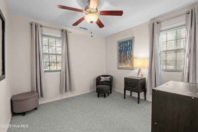 sitting room with light carpet, ceiling fan, visible vents, and baseboards