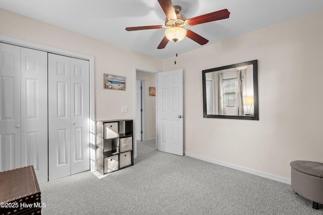 bedroom with a ceiling fan, baseboards, a closet, and light colored carpet