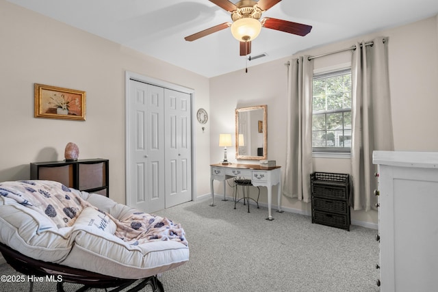 bedroom featuring a closet, visible vents, a ceiling fan, light carpet, and baseboards