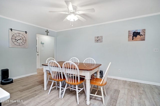 dining room featuring crown molding, ceiling fan, and light wood-type flooring