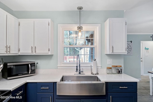 kitchen featuring white cabinetry, sink, decorative light fixtures, and black electric range oven