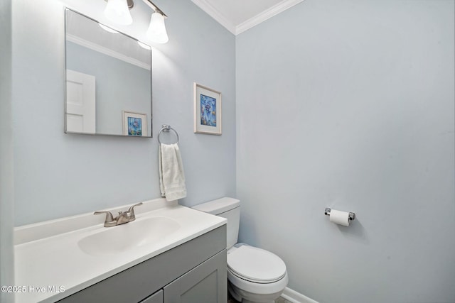 bathroom featuring ornamental molding, vanity, and toilet