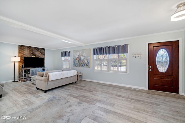 interior space with ornamental molding, a healthy amount of sunlight, and light wood-type flooring