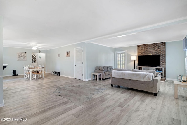 living room featuring crown molding, light hardwood / wood-style flooring, and ceiling fan