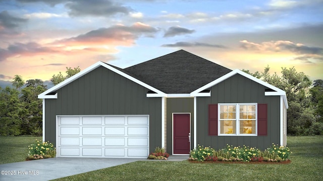 view of front of home with a yard and a garage