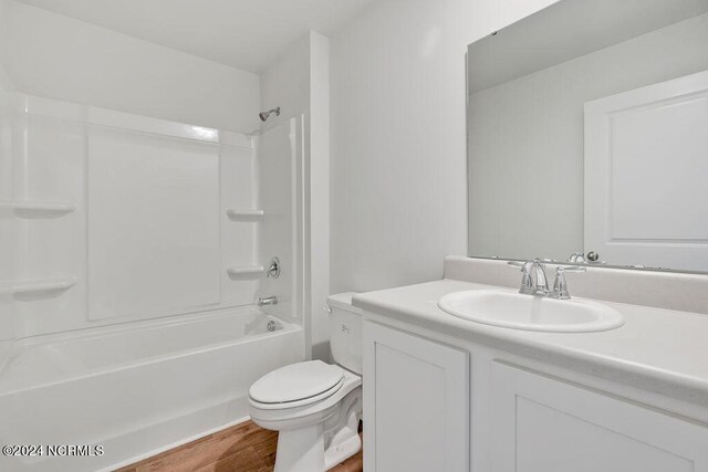 full bathroom featuring shower / tub combination, wood-type flooring, vanity, and toilet