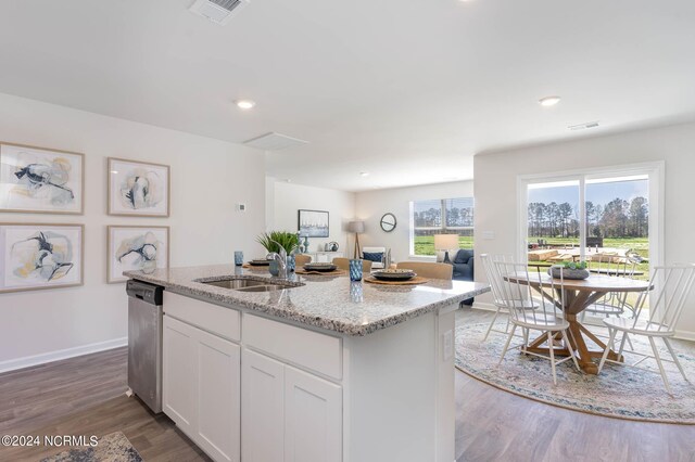 kitchen with white cabinetry, stainless steel appliances, light stone counters, and light wood-type flooring