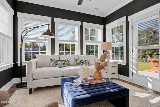 sunroom featuring ceiling fan