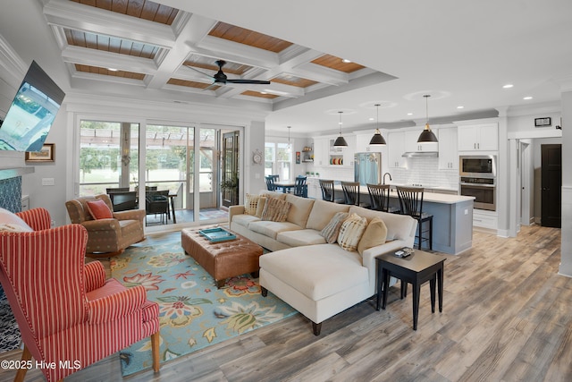 1611 Golfers Ridge Dr SE, Bolivia, NC 28422 - living room with recessed lighting, crown molding, ceiling fan, light wood-style floors, and coffered ceiling